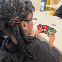 a teen showing their Uno hand